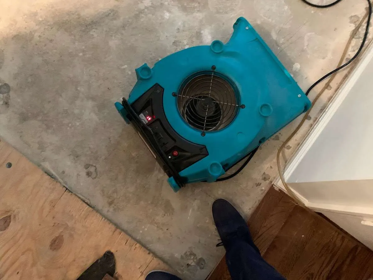 Air mover drying subfloor during Commercial Water Damage Restoration in Benbrook